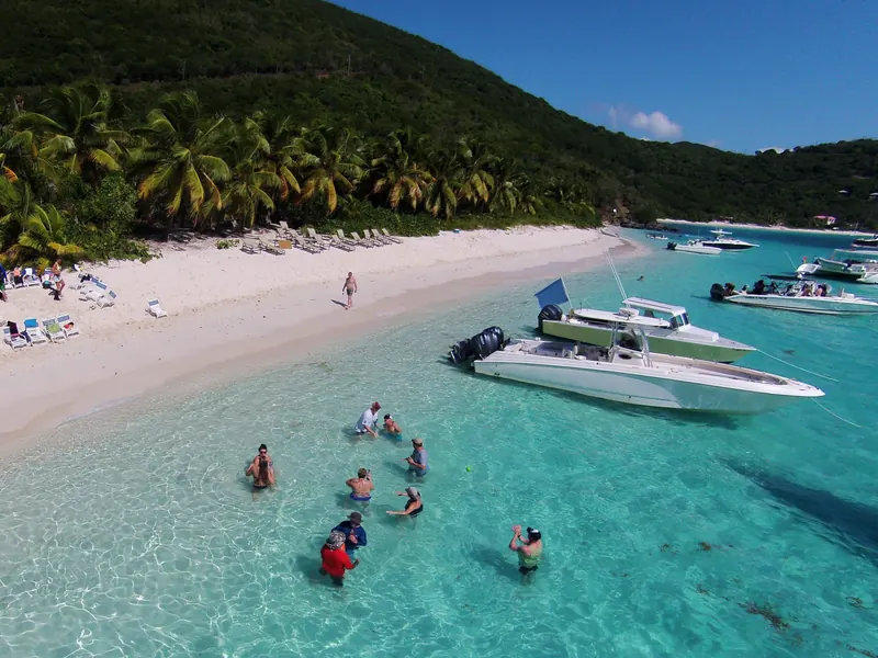Swimmers and anchored boats in the turquoise shallows of White Bay, Jost Van Dyke, BVI